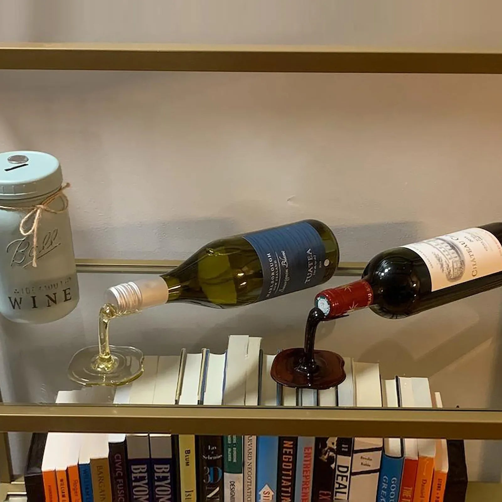 The Spilled Wine Bottle Holder creates the optical illusion of the wine bottle floating in the air and spilling out liquid onto the surface. 